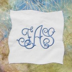Custom made bespoke machine embroidery monogram FAS monogrammed on a patchwork quilt from Needle Passion Embroidery